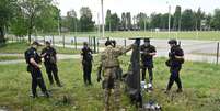 Especialistas em explosivos e policiais ucranianos examinam partes de um drone militar Shahed 136 que caiu após um ataque aéreo em Kharkiv, em 4 de junho de 2025, na Ucrânia. (Foto de SERGEY BOBOK / AFP)  Foto: AFP - SERGEY BOBOK / RFI